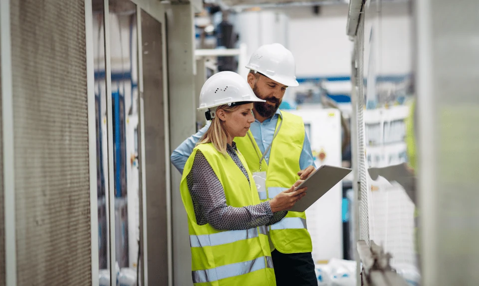 Warehouse colleague reviewing an inventory list